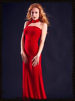 Wearing stylish red dress that hugs her body curves, her red hair elegantly cascading into curls, Aislin's exotically girlish beauty with womanly allure can make any man down to his knees.